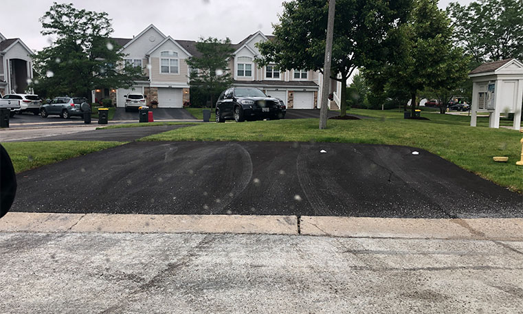 completed asphalt driveway in front of home